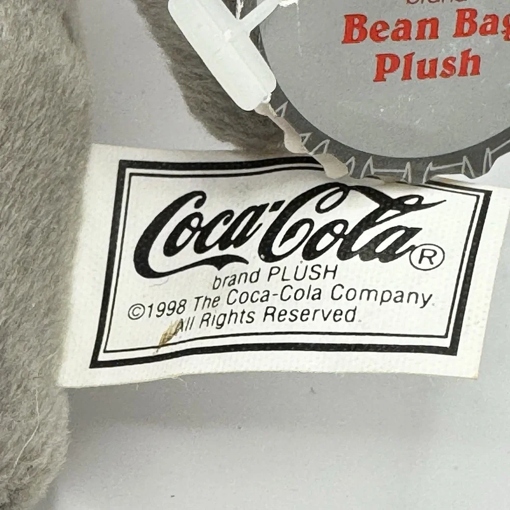 Coca-Cola collectible bean‎ bag plush seal from 1998, wearing a delivery outfit
